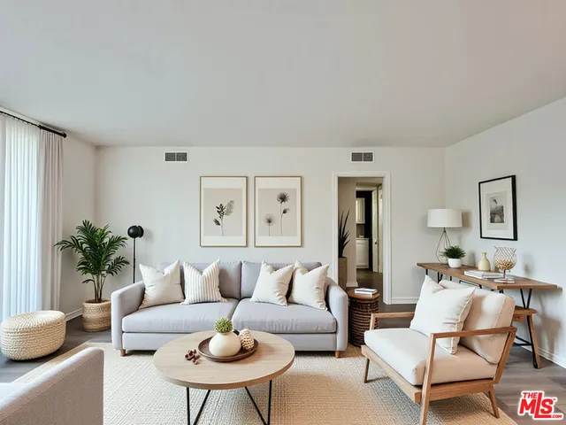 a living room with furniture and a potted plant
