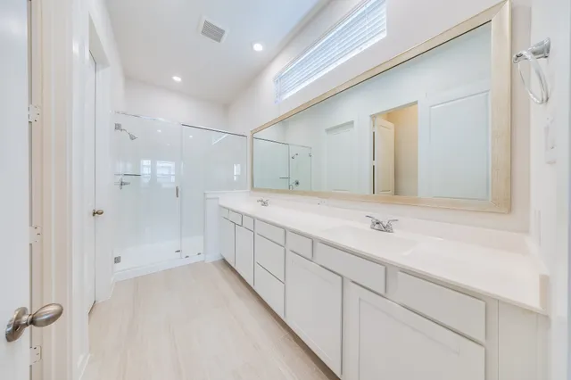 a bathroom with a double vanity sink and mirror