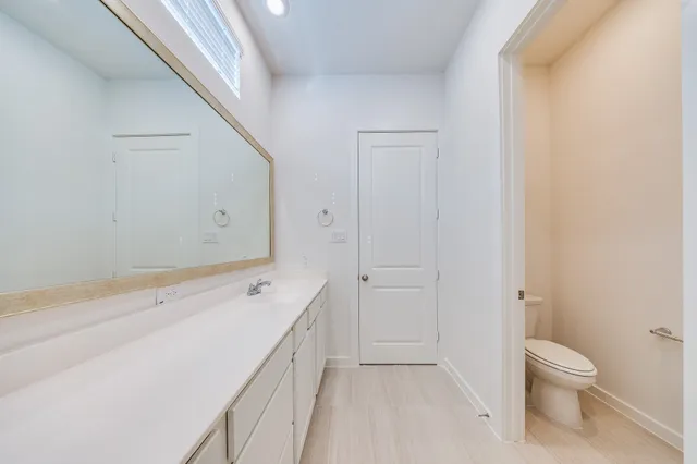 a spacious bathroom with a granite countertop sink