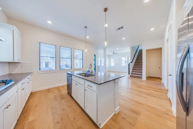 a kitchen with granite countertop a stove and a sink