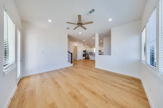 wooden floor in an empty room with a window