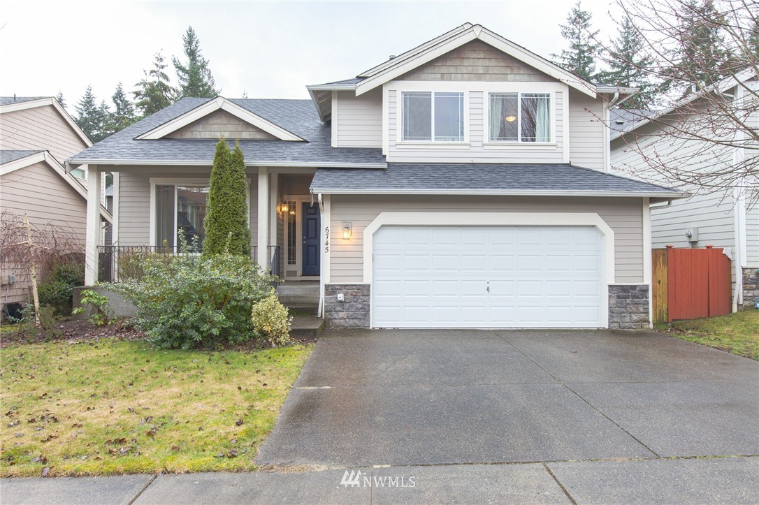 6745 Southeast 5th Street Renton, WA 98059 - Photo 1 of 25 a front view of a house with garden