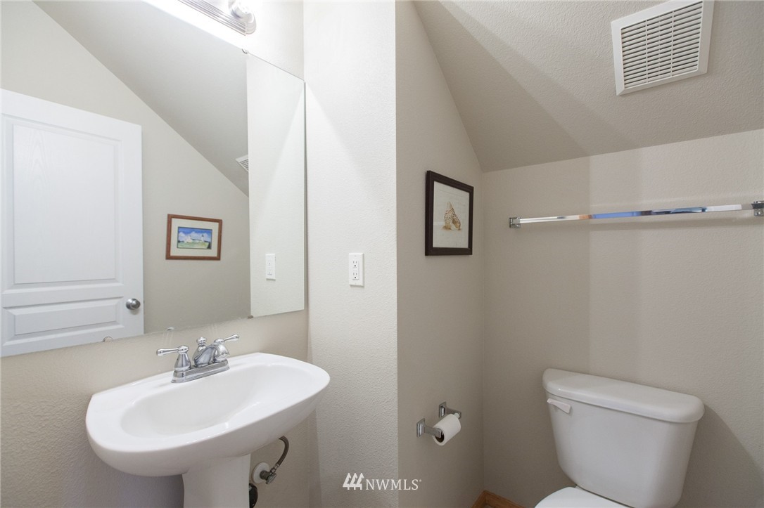 6745 Southeast 5th Street Renton, WA 98059 - Photo 13 of 25 a bathroom with a sink a mirror and a toilet