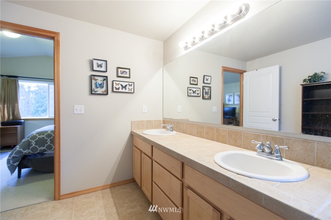 6745 Southeast 5th Street Renton, WA 98059 - Photo 16 of 25 a bathroom with a sink double vanity and a mirror