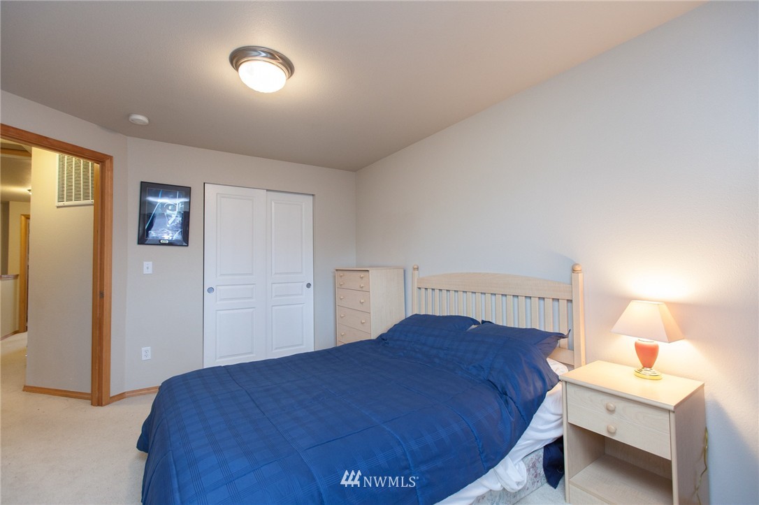 6745 Southeast 5th Street Renton, WA 98059 - Photo 20 of 25 a bedroom with a bed and a lamp
