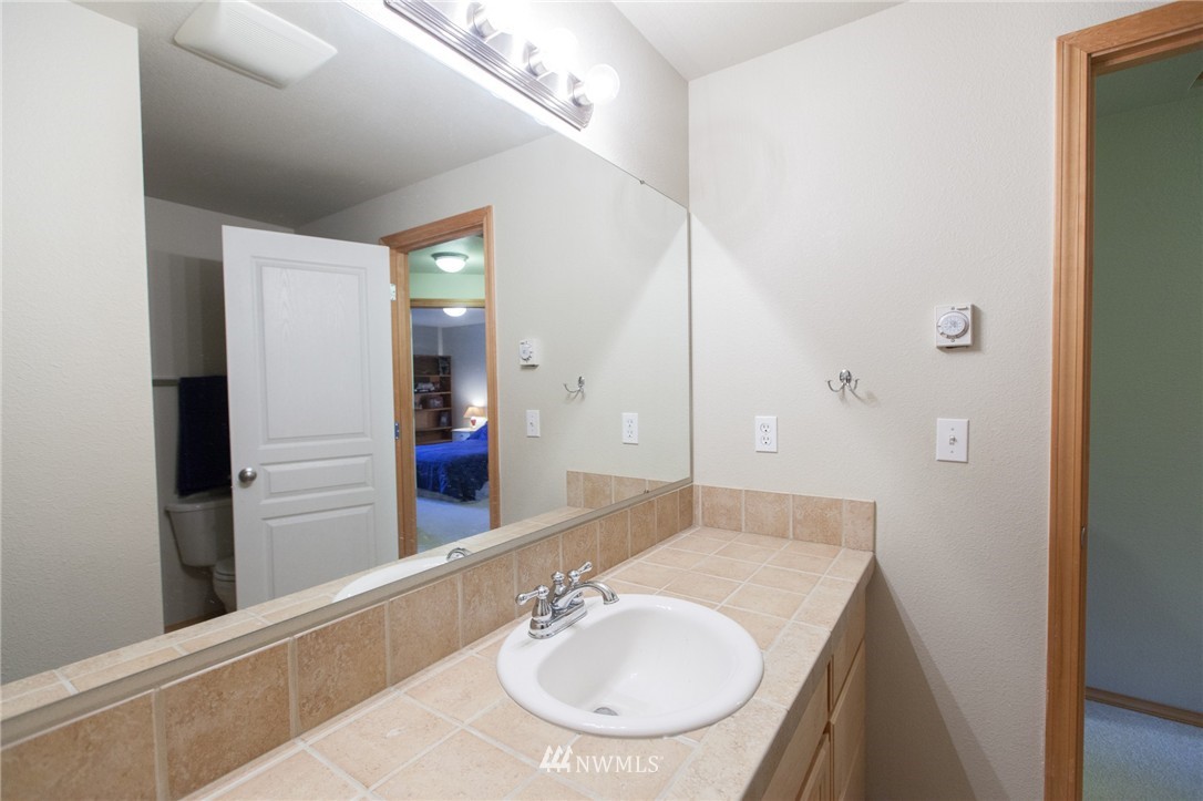 6745 Southeast 5th Street Renton, WA 98059 - Photo 22 of 25 a bathroom with a sink and a mirror