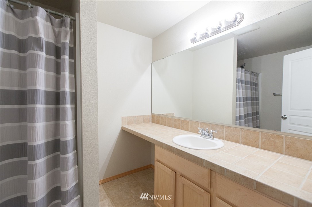 6745 Southeast 5th Street Renton, WA 98059 - Photo 23 of 25 a bathroom with a sink and a mirror