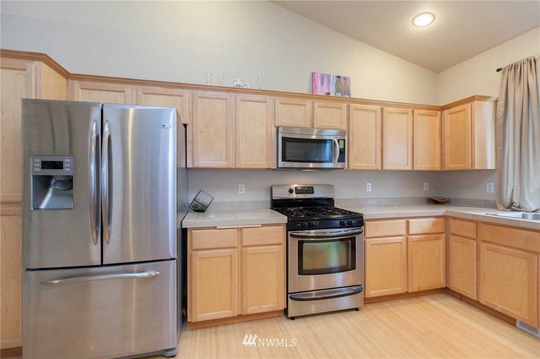 6745 Southeast 5th Street Renton, WA 98059 - Photo 7 of 25 a kitchen with a refrigerator stove and microwave