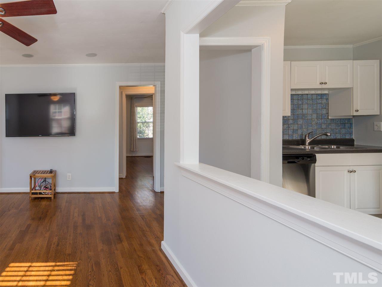 1800 Bennett Street Raleigh, NC 27604 - Photo 4 of 24 The peek-a-boo passthrough between the kitchen and Living Room allows for more connectivity and inclusiveness between spaces.