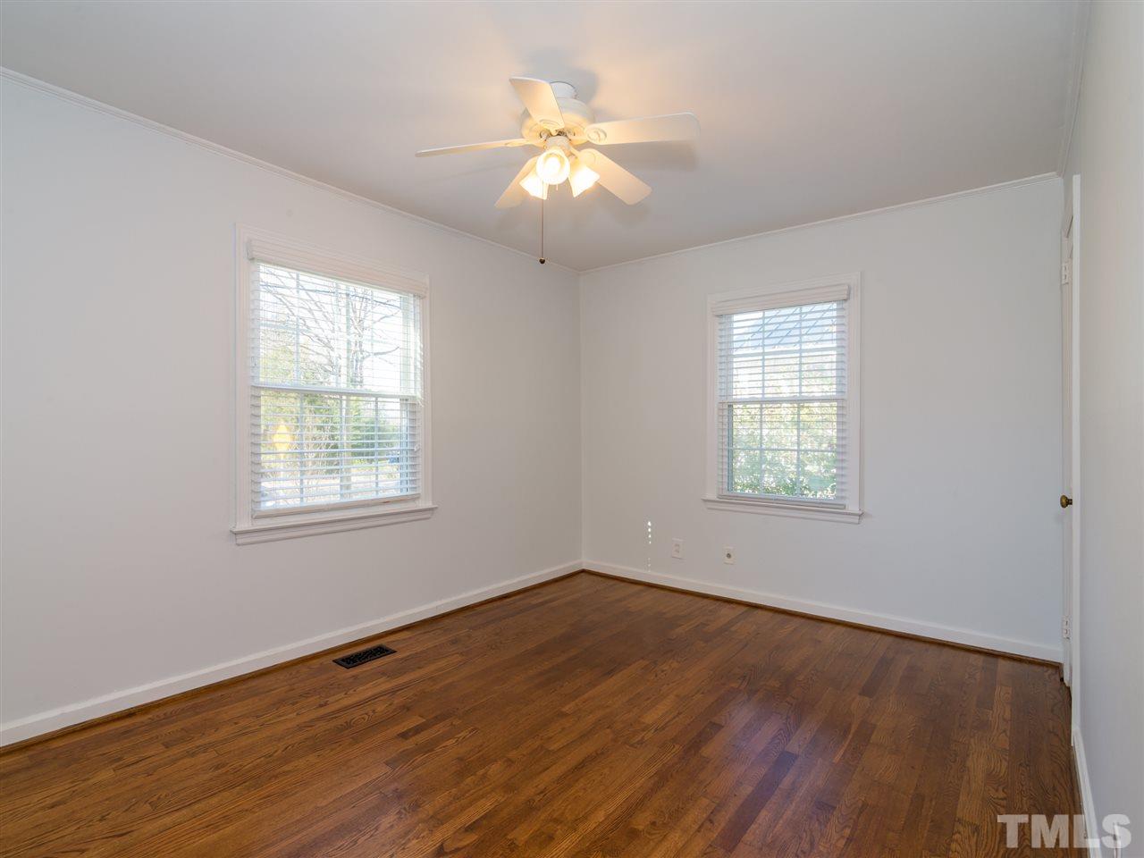 1800 Bennett Street Raleigh, NC 27604 - Photo 7 of 24 The second bedroom is situated toward the front of the house. The window to the left overlooks the two Redbud trees in the front yard. The window to the right overlooks a hedge of honeysuckle.