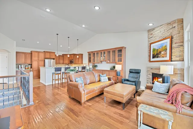 a open kitchen with stainless steel appliances granite countertop a stove top oven a sink dishwasher a refrigerator and a kitchen island