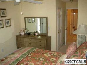 8320 Rudolph Road Charlotte, NC 28216 - Photo 5 of 8 a room with a bed and a dresser