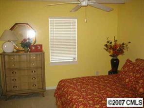 8320 Rudolph Road Charlotte, NC 28216 - Photo 7 of 8 a bedroom with a bed and a mirror