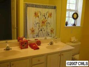 8320 Rudolph Road Charlotte, NC 28216 - Photo 8 of 8 a bathroom with a sink and a mirror