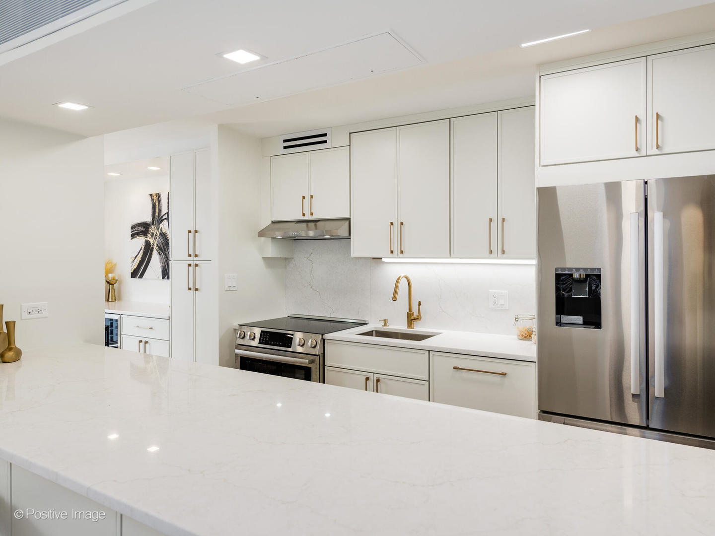 1310 North Ritchie Court, Unit 27C Chicago, IL 60610 - Photo 11 of 30 a kitchen with white cabinets and stainless steel appliances