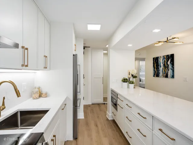 a spacious bathroom with a sink double vanity and a mirror