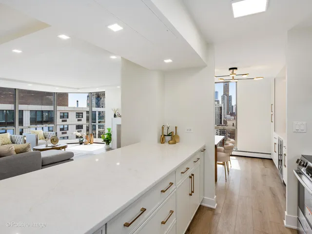 a view of a living room and hallway with wooden floor