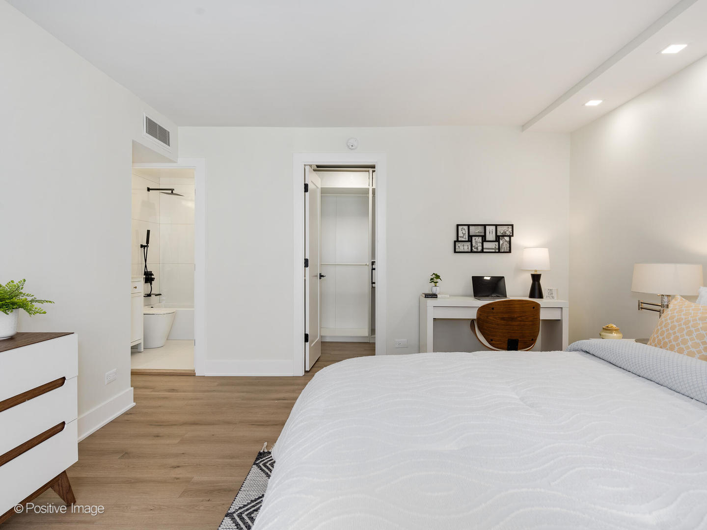 1310 North Ritchie Court, Unit 27C Chicago, IL 60610 - Photo 16 of 30 a bedroom with a bed and wooden floor