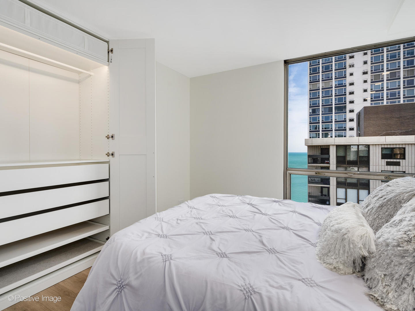 1310 North Ritchie Court, Unit 27C Chicago, IL 60610 - Photo 24 of 30 a bedroom with a bed and a window