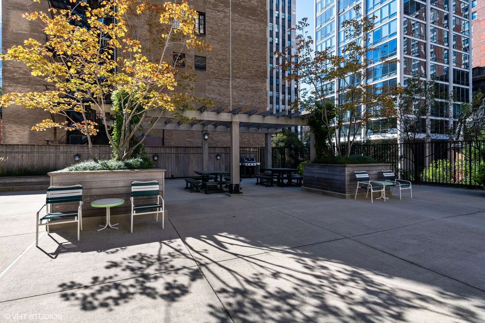 1310 North Ritchie Court, Unit 27C Chicago, IL 60610 - Photo 30 of 30 a view of a patio with table and chairs with plants and trees