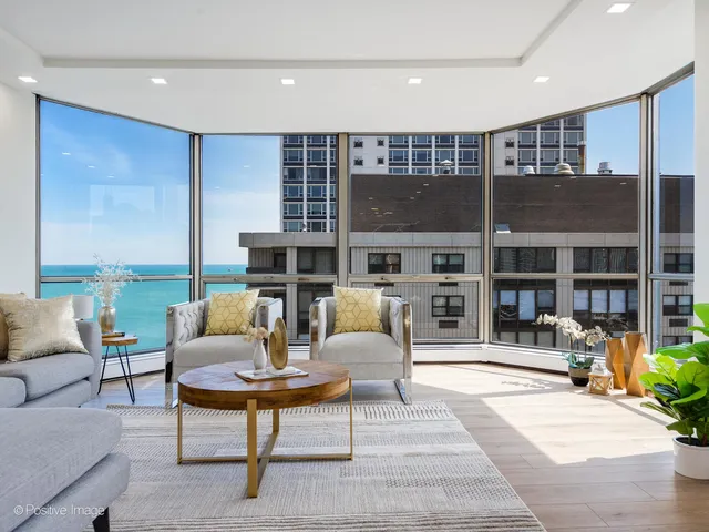 a living room with furniture a rug and a large window