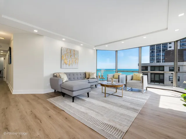 a living room with furniture and a large window