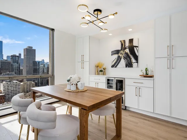 a view of a dining room with furniture and a potted plant