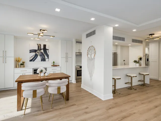 a view of a dining room with furniture and chandelier
