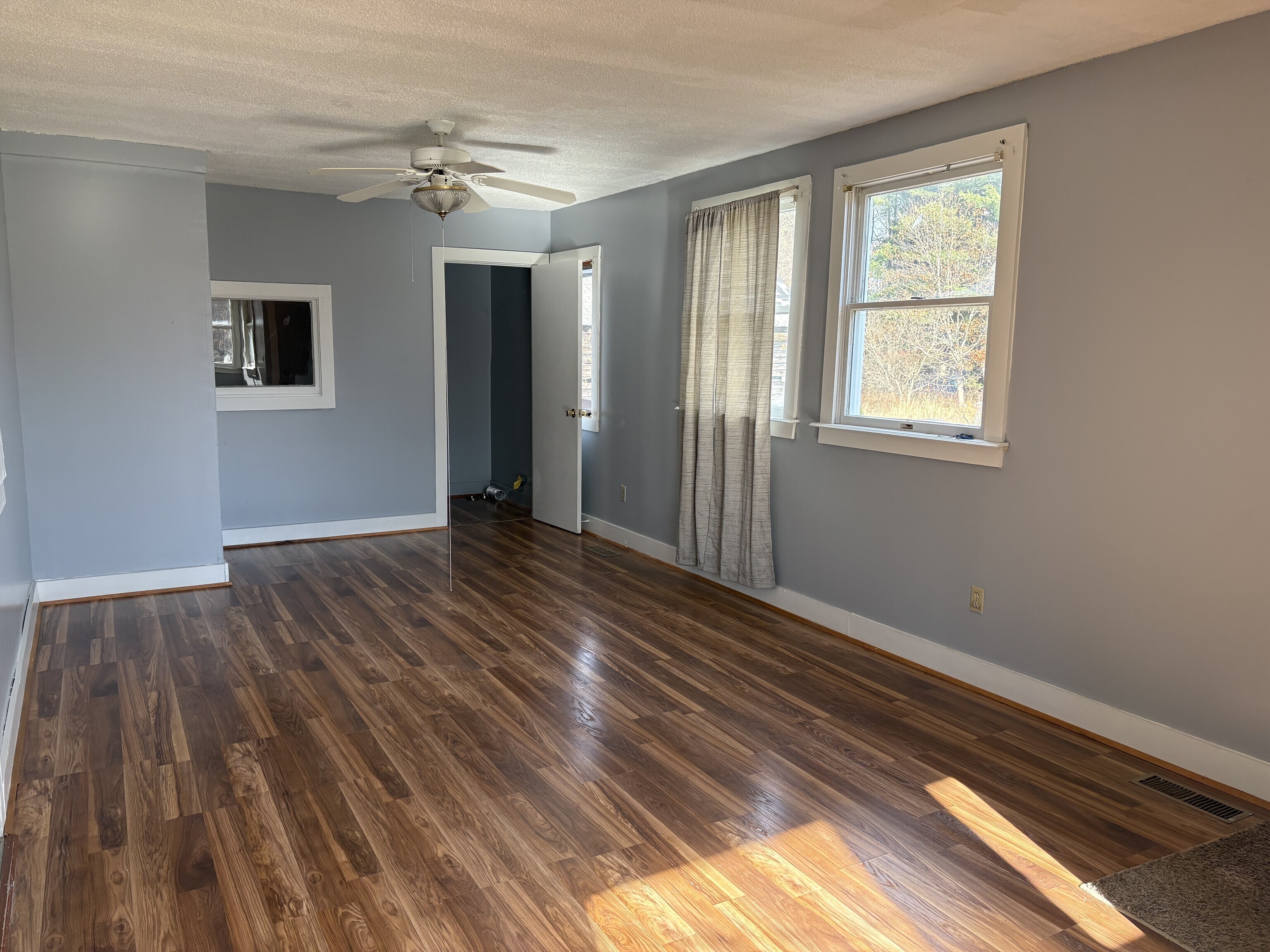 152 Blacks Road Cheshire, CT 06410 - Photo 8 of 14 a view of an empty room with wooden floor and a window
