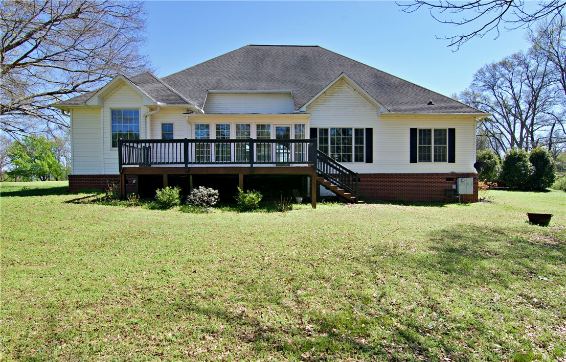 7893 Athens Road Carnesville, GA 30521 - Photo 32 of 50 This spacious house features a large backyard and an inviting deck, perfect for outdoor enjoyment.