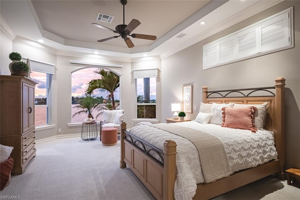 1942 Kingfish Road Naples, FL 34102 - Photo 22 of 43 a bedroom with a bed couch and a chandelier