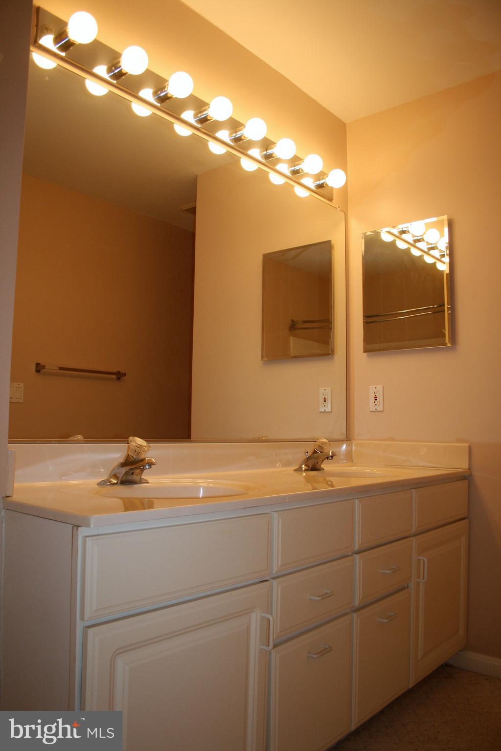 35 F Queen Anne Way Chester, MD 21619 - Photo 11 of 20 a bathroom with a sink and a mirror