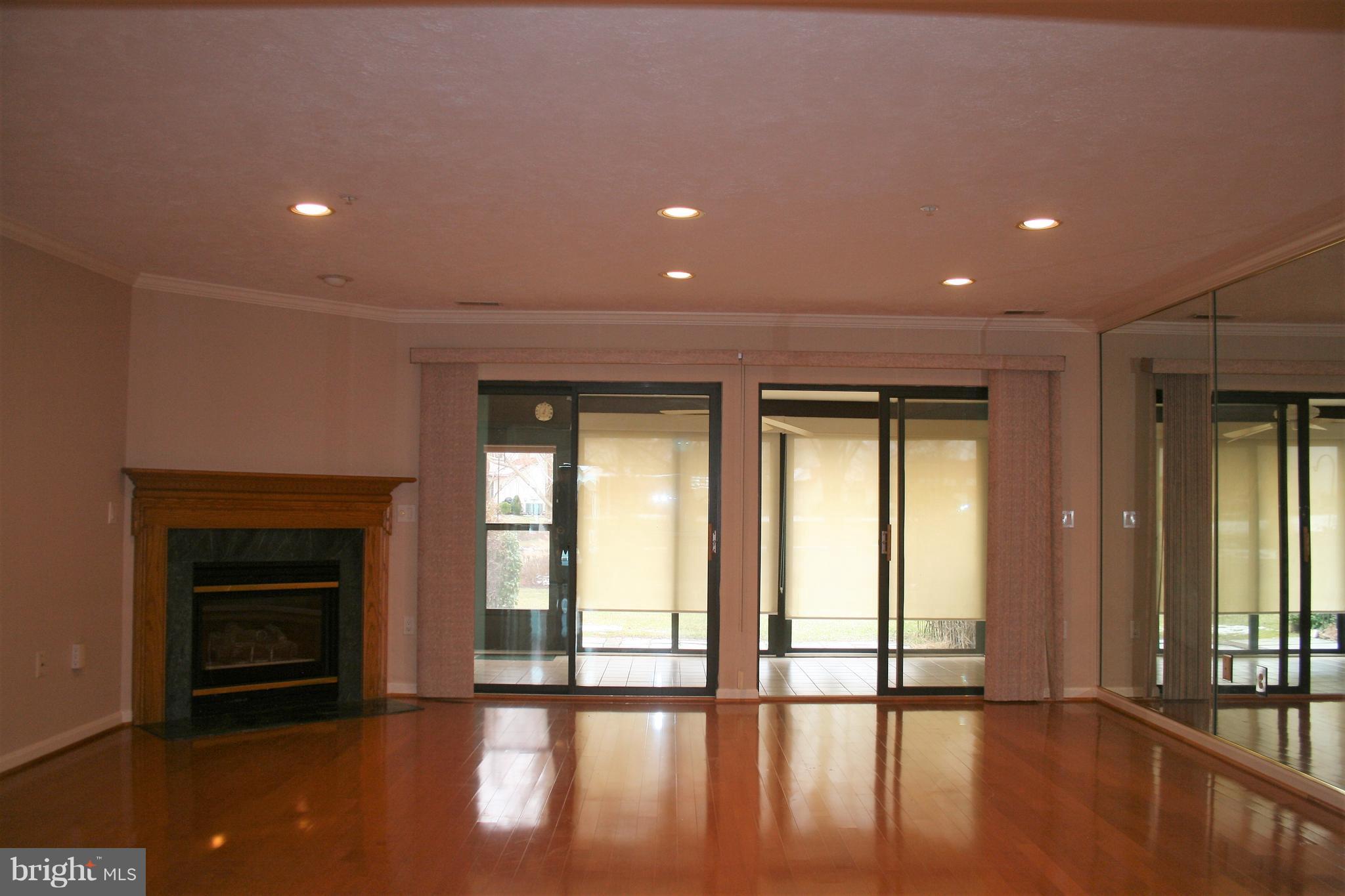 35 F Queen Anne Way Chester, MD 21619 - Photo 7 of 20 a view of an empty room with wooden floor and a fireplace