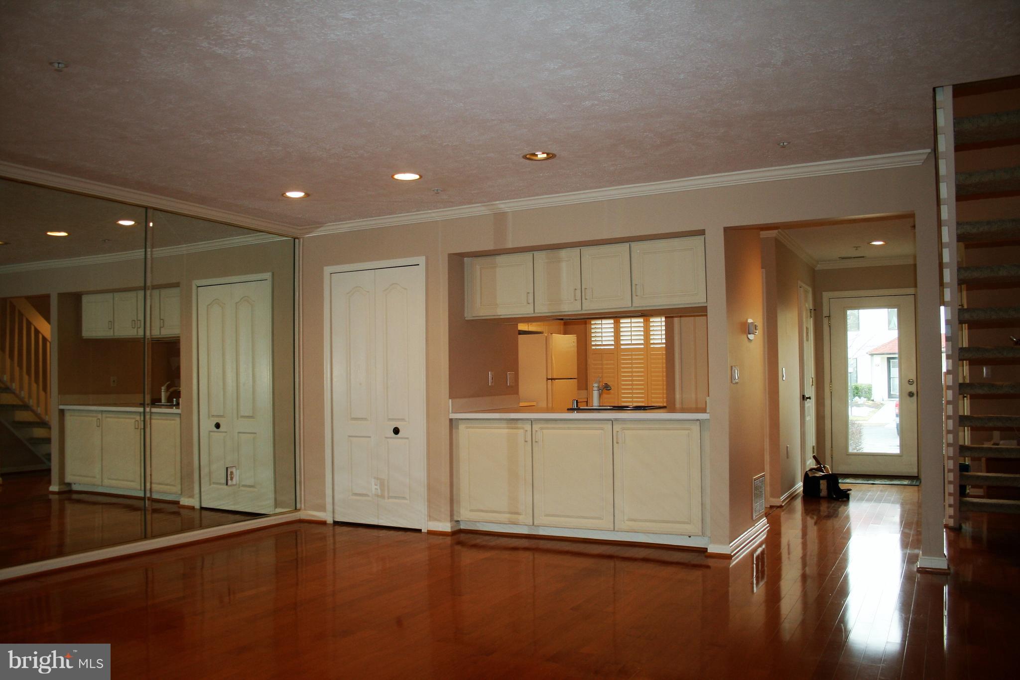 35 F Queen Anne Way Chester, MD 21619 - Photo 8 of 20 an empty room with wooden floor and windows