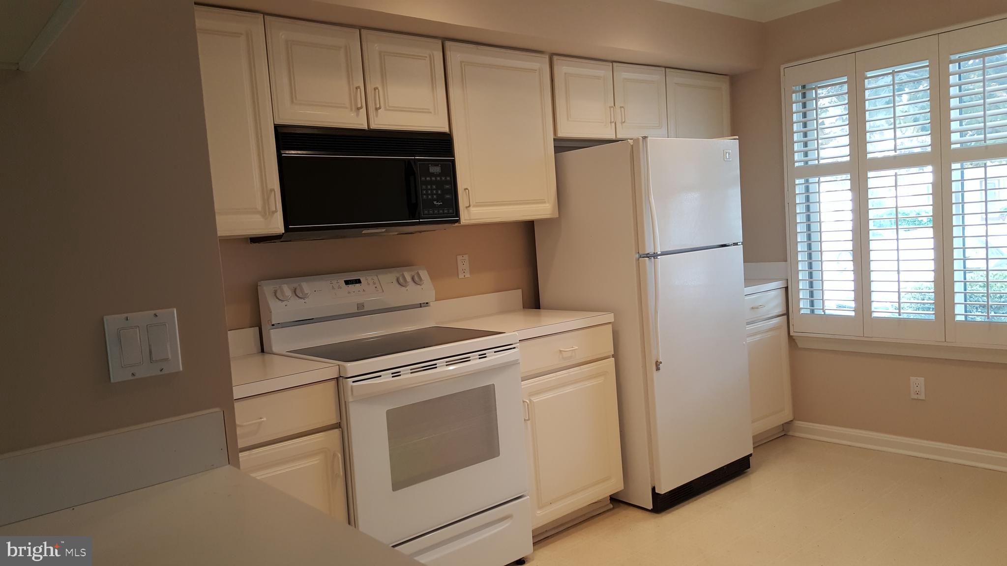 35 F Queen Anne Way Chester, MD 21619 - Photo 9 of 20 a kitchen with a stove microwave and refrigerator