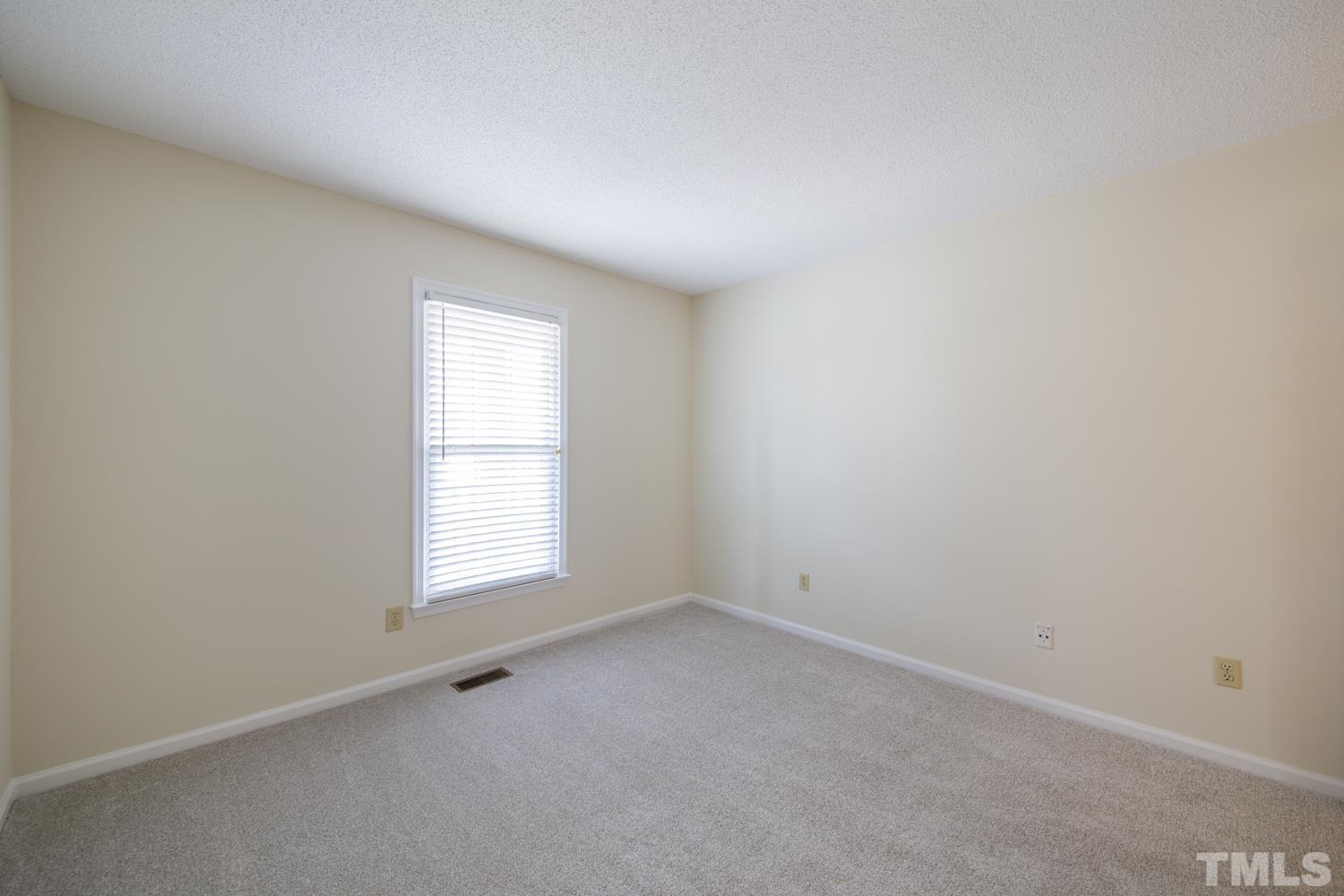 11805 North Exeter Way Raleigh, NC 27613 - Photo 14 of 19 an empty room with a window