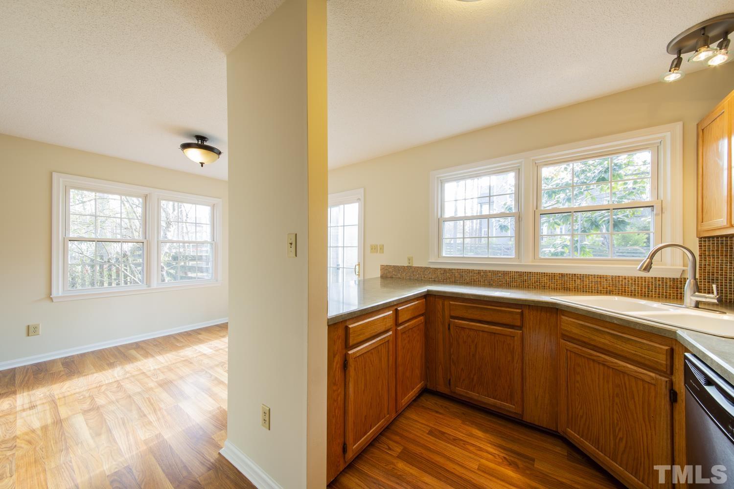 11805 North Exeter Way Raleigh, NC 27613 - Photo 10 of 19 a kitchen with a sink and large window