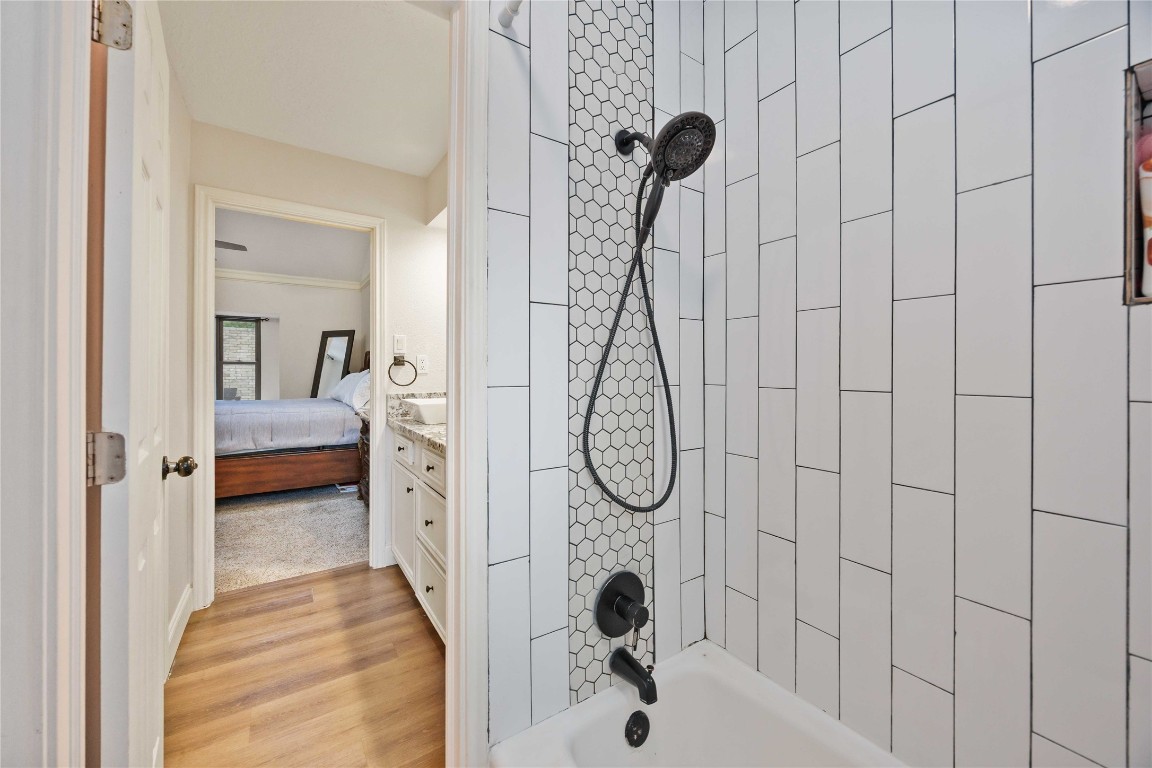 7310 Hickory Lane Baytown, TX 77521 - Photo 15 of 17 a en suite bathroom with a shower and tub