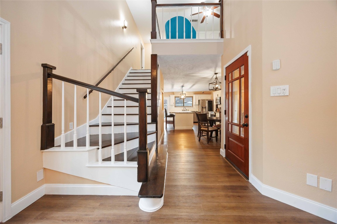 7310 Hickory Lane Baytown, TX 77521 - Photo 5 of 17 a view of a hallway with wooden floor and staircase