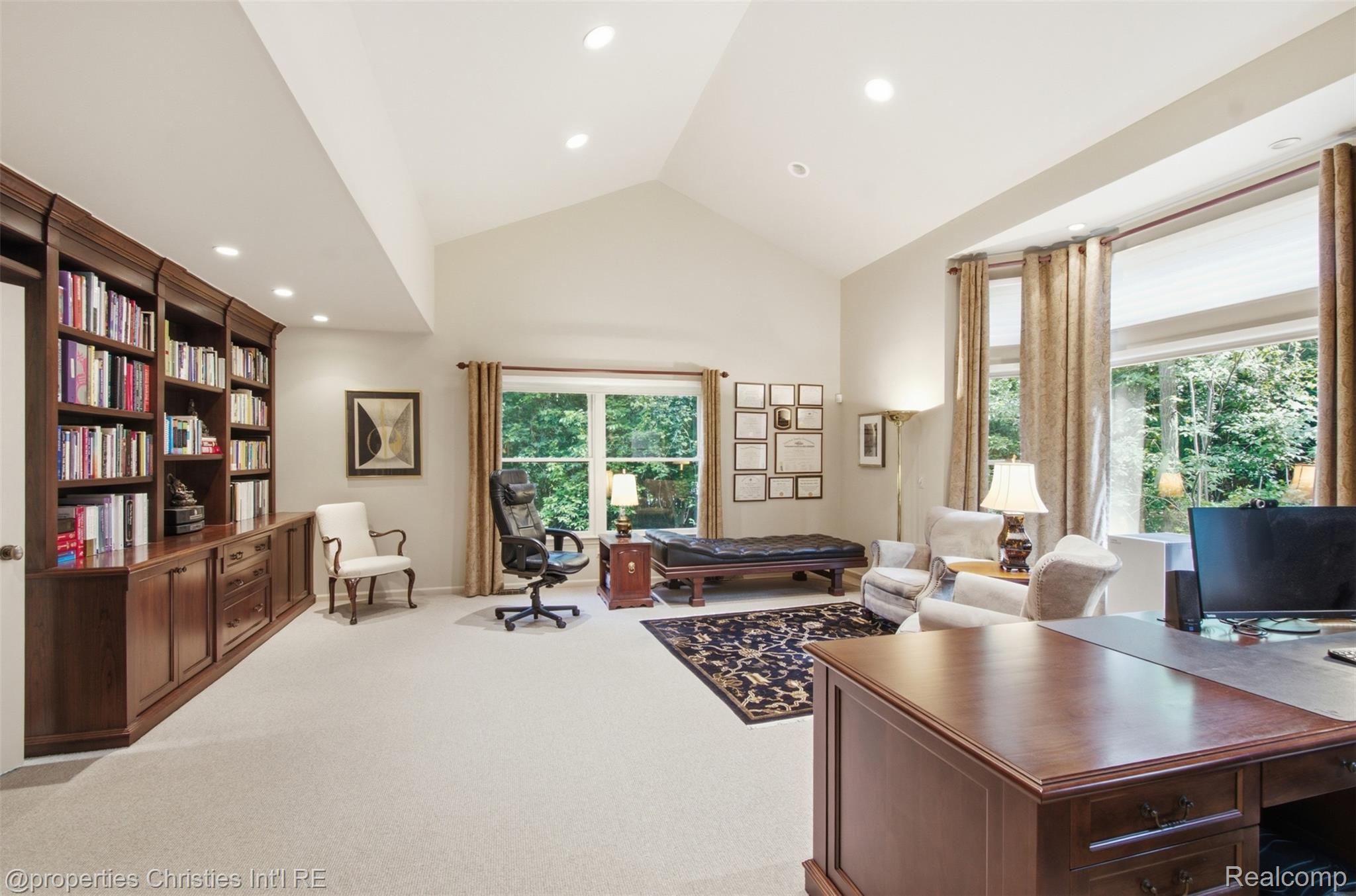 25235 Canterbury Road Franklin, MI 48025 - Photo 9 of 56 Vaulted ceiling room featuring extensive built-in cabinetry, bookshelves and desk