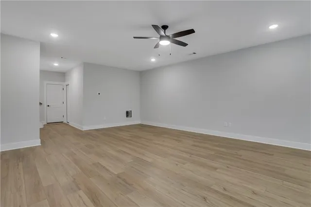 an aerial view of residential houses with outdoor space and trees