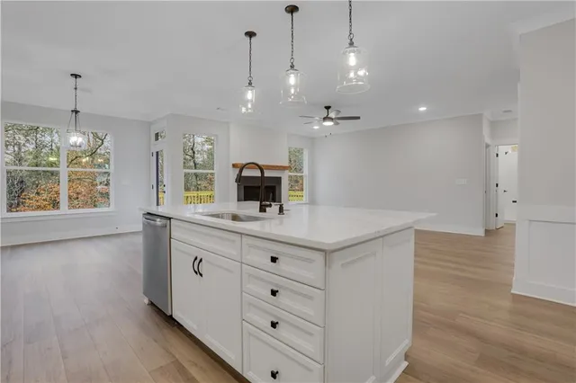 a bathroom with a granite countertop sink a toilet and shower