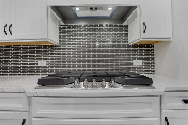 a bathroom with a granite countertop sink a toilet and mirror