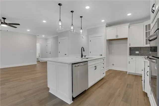 a bathroom with a granite countertop sink a toilet and shower