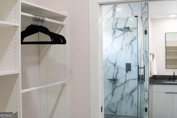 a bathroom with a shower and a sink