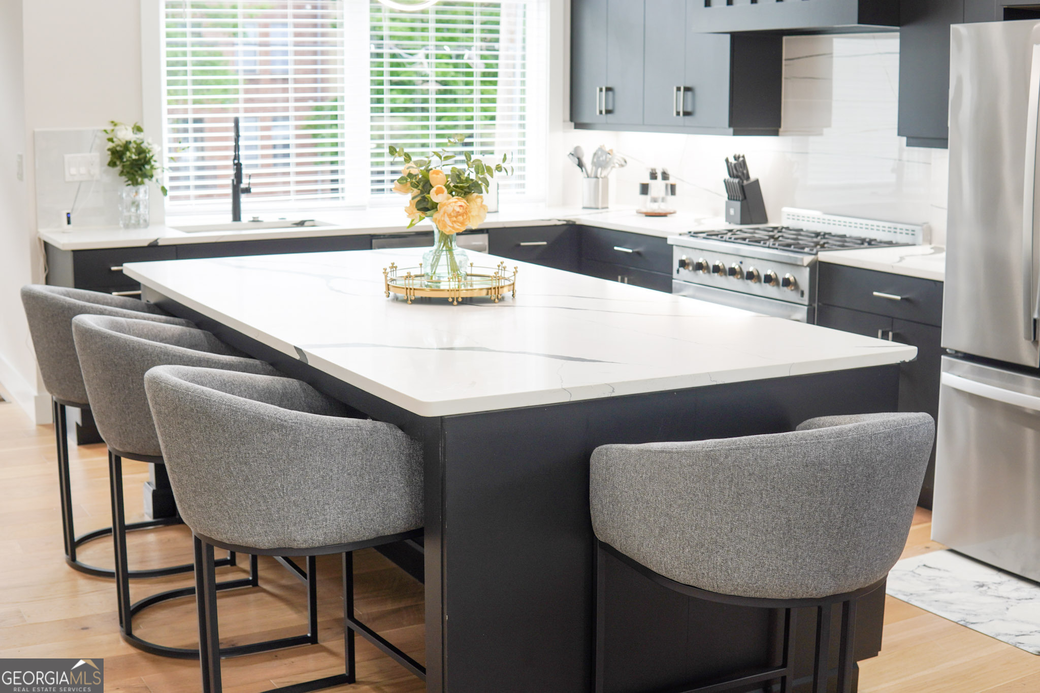 68 Boulevard Southeast Atlanta, GA 30312 - Photo 30 of 51 a kitchen with stainless steel appliances kitchen island a table chairs and a refrigerator