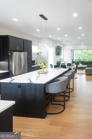 a kitchen with a sink a counter and chairs