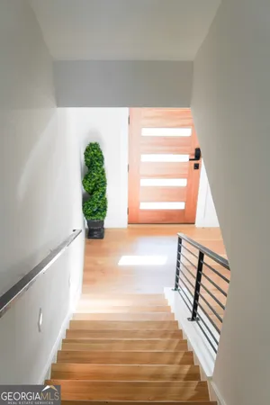 a view of entryway and hall with wooden floor