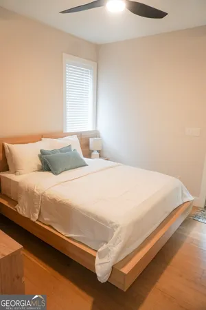 a bedroom with a bed and a flat screen tv