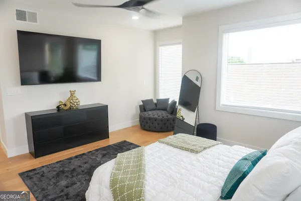 a bedroom with a bed and a flat screen tv